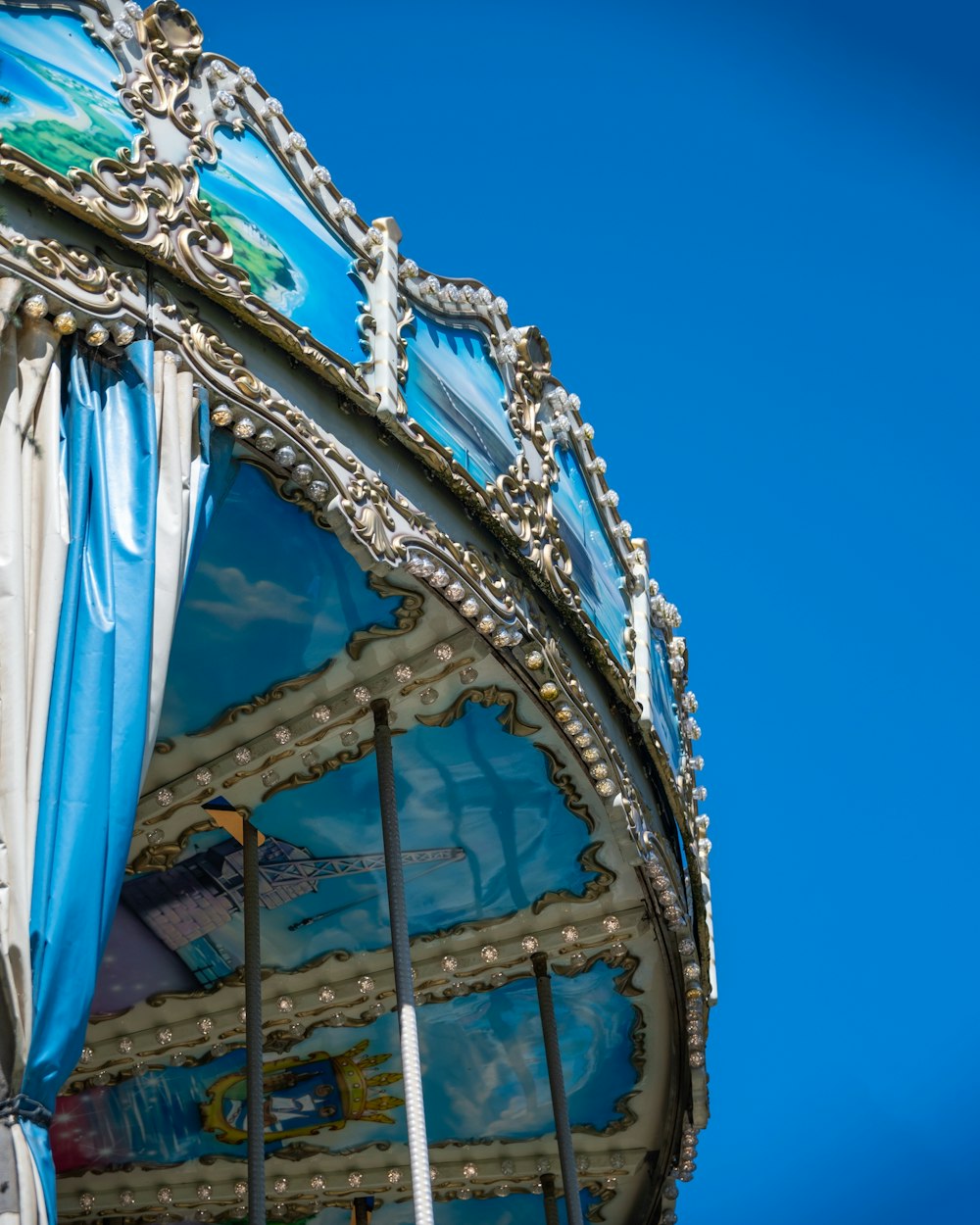 a close up of a carnival ride against a blue sky