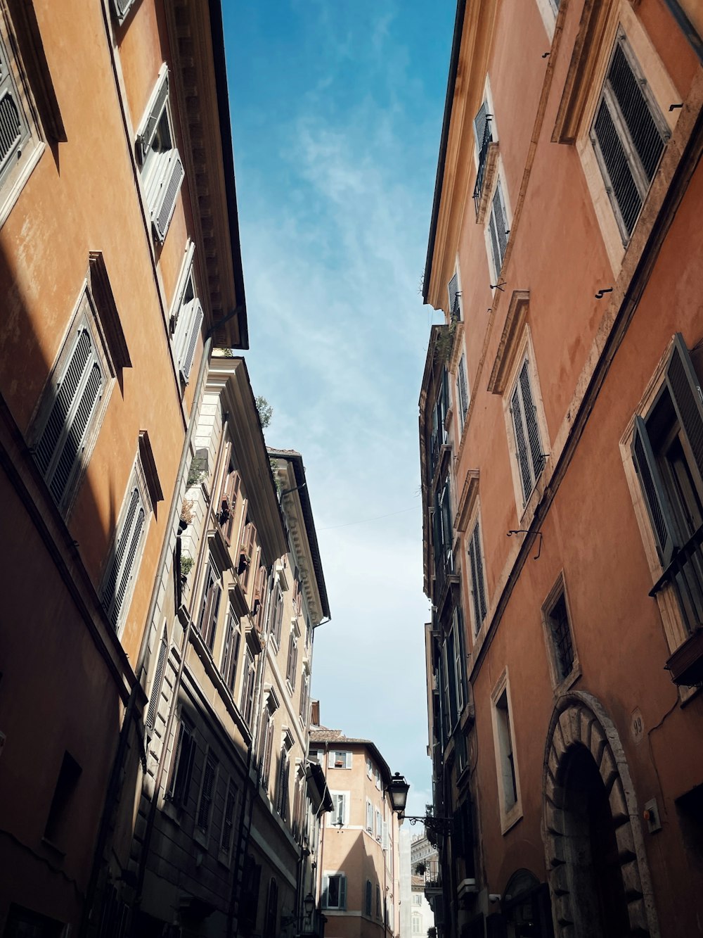 a narrow street with buildings and a sky background