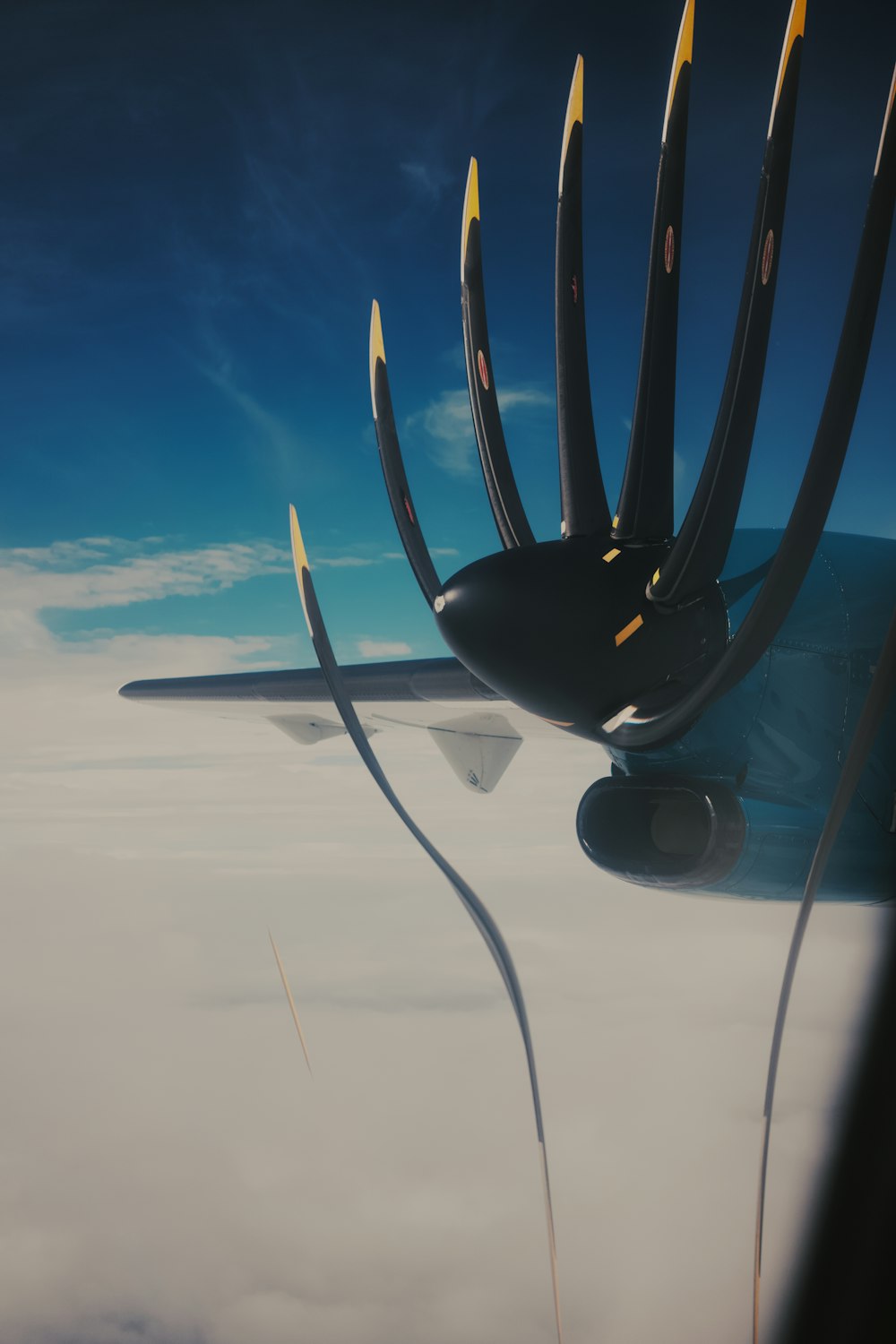 a jetliner flying through a blue cloudy sky