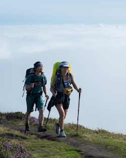 a couple of people walking up a hill