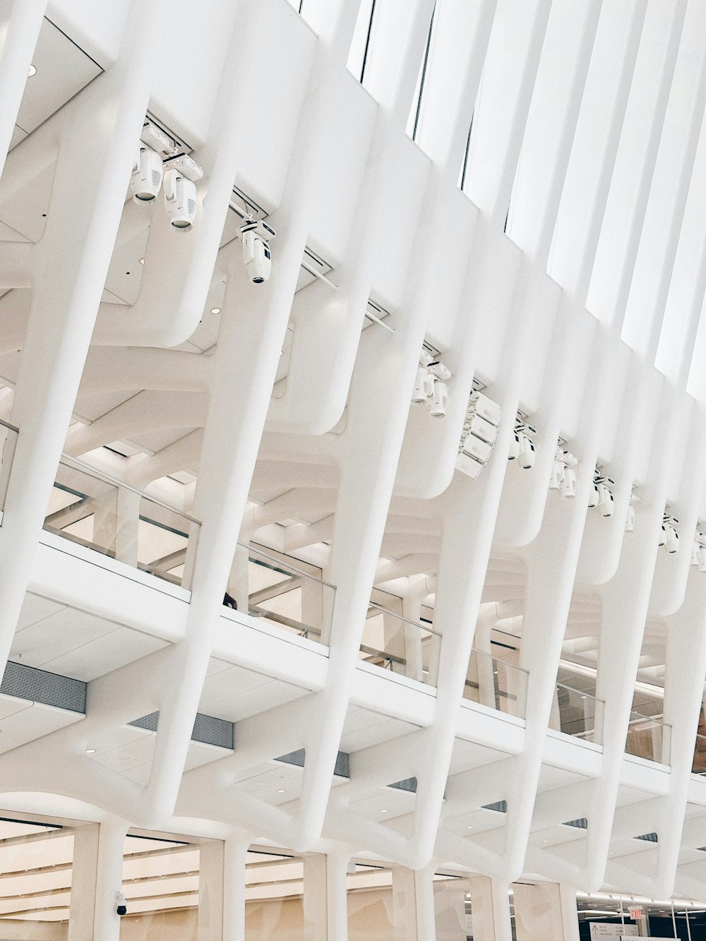 a group of white pipes hanging from the ceiling of a building