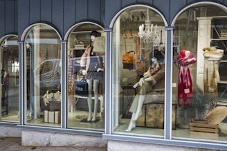 a window display of mannequins in a store
