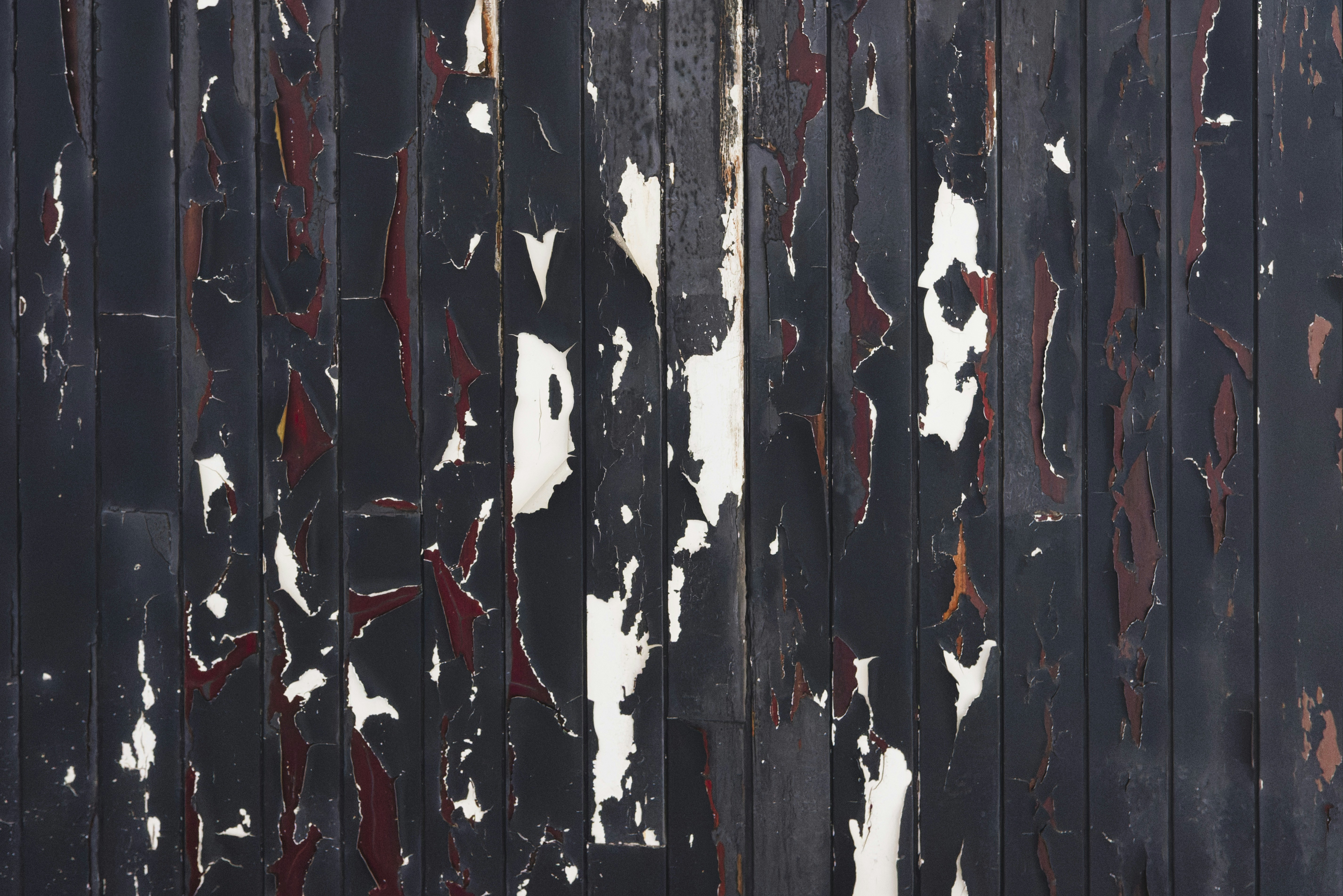 a wooden fence with peeling paint on it