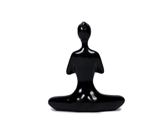 A handcrafted figurine with smooth curves and a glossy finish, capturing a unique pose.