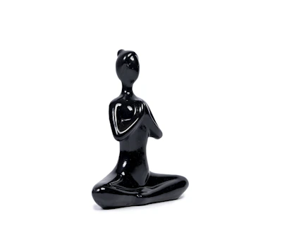 An artistic ceramic sculpture with smooth curves and a matte finish.
