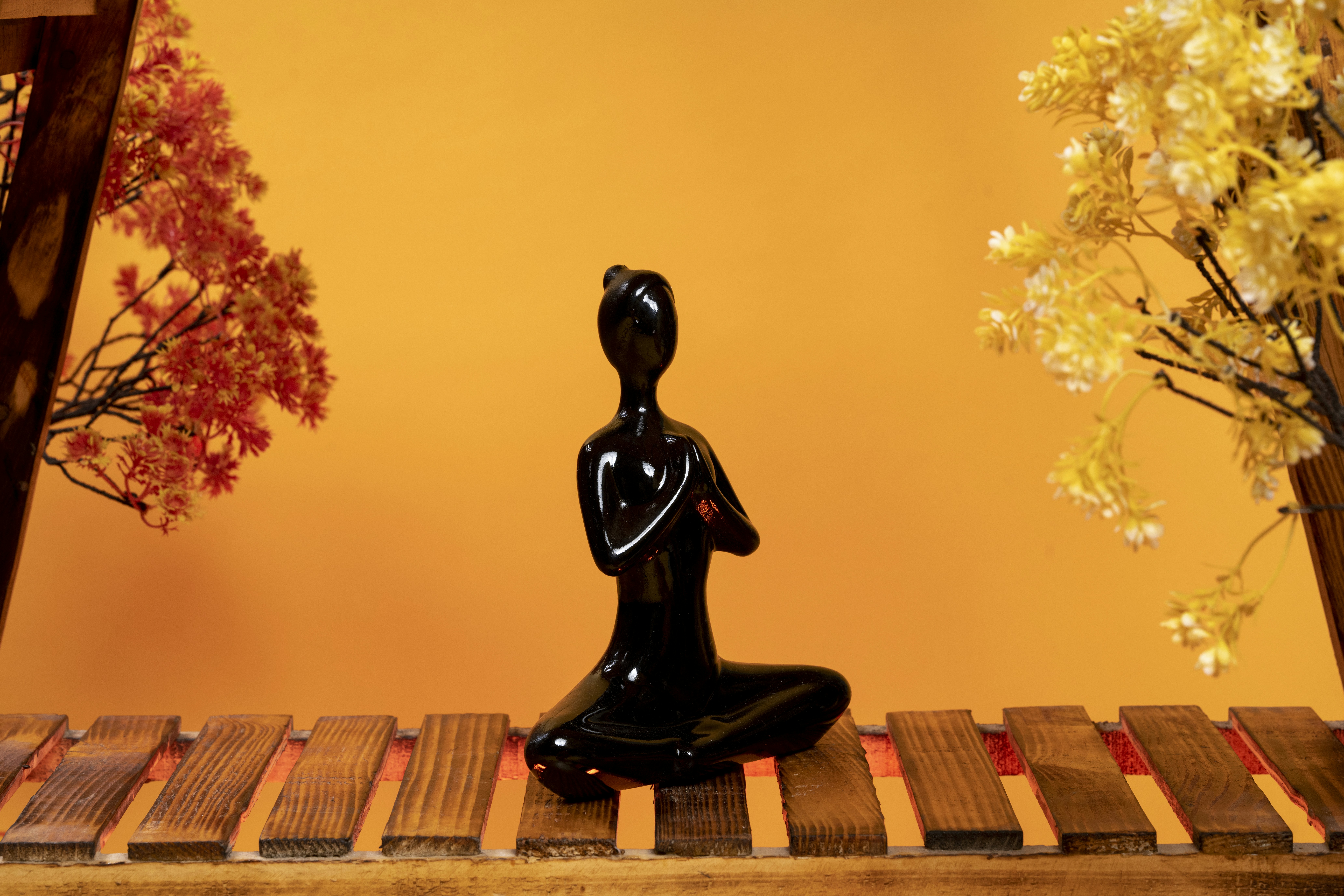 Black statue on wooden table