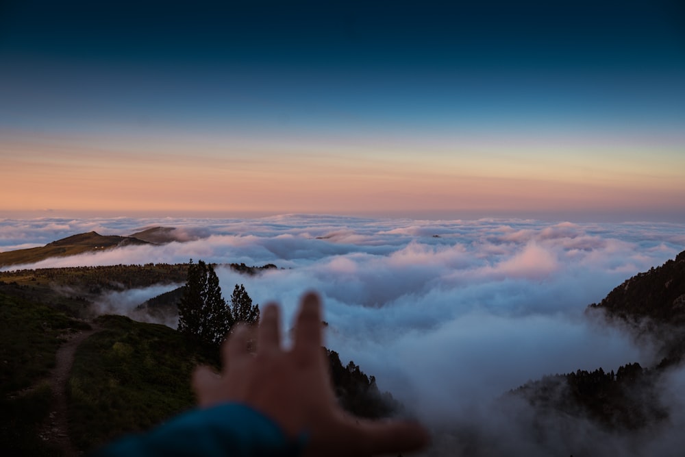 a person is taking a picture of the clouds