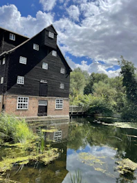 Wide shot of a partially restored old mill showing new and original materials.