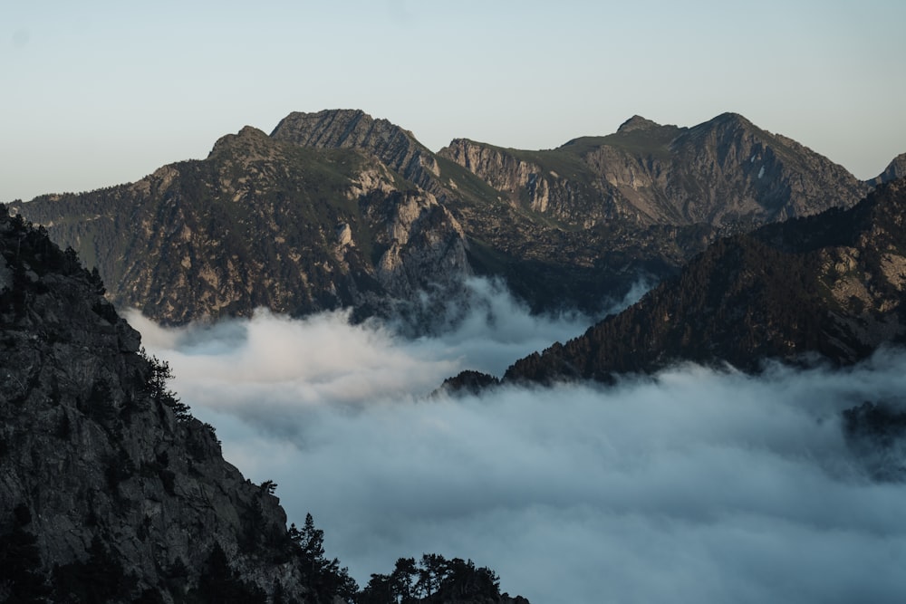 a view of a mountain range covered in clouds