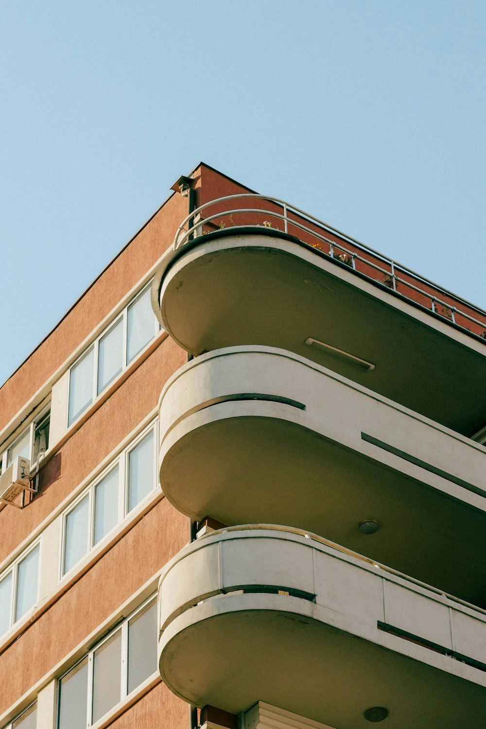 a tall building with balconies on top of it