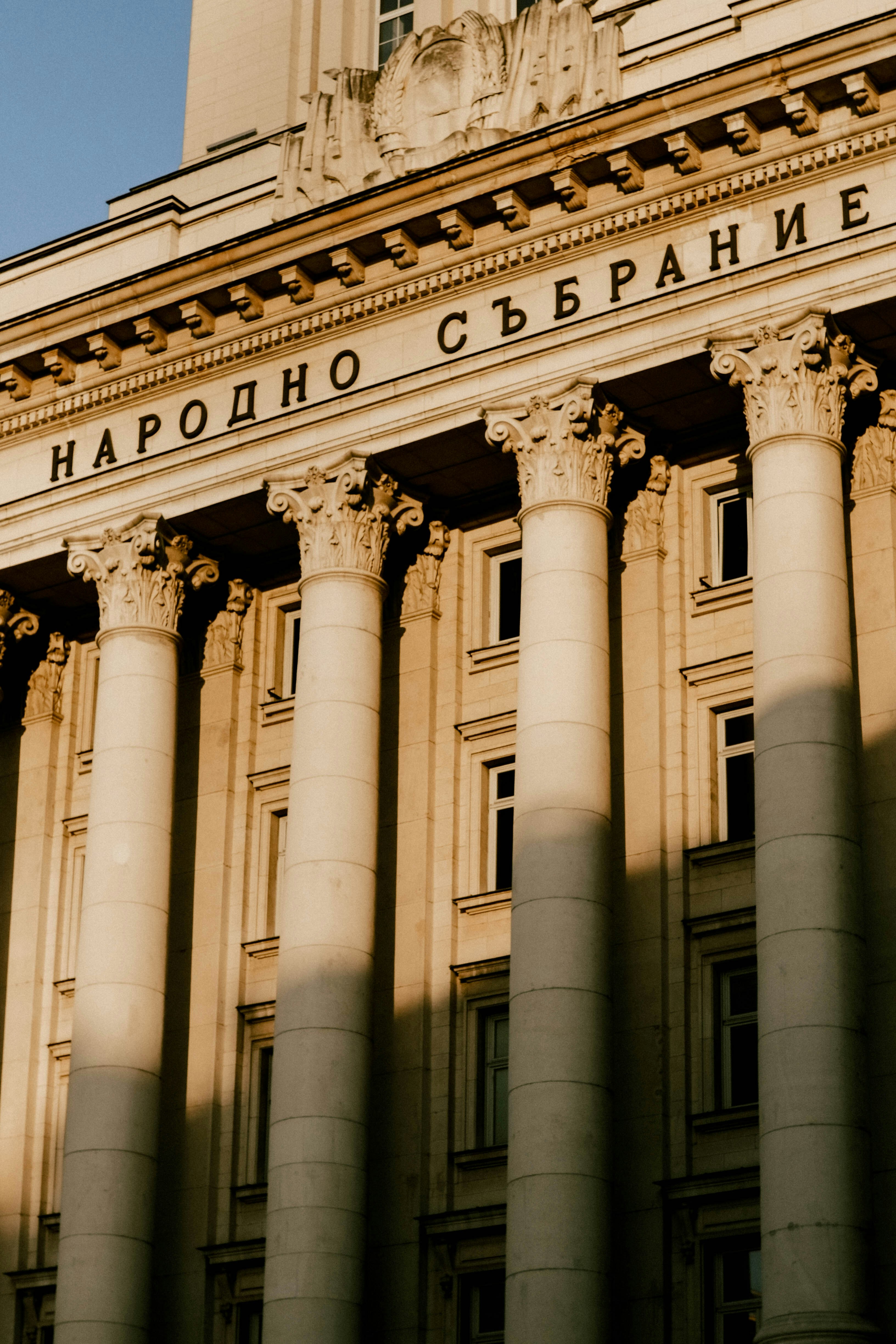 a building with columns and a clock tower