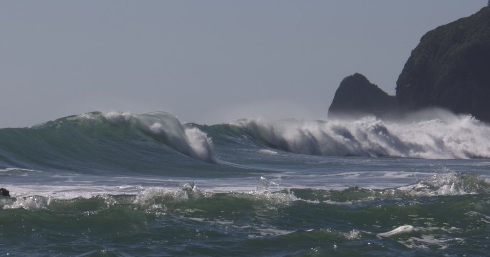 a person riding a surfboard on a wave in the ocean