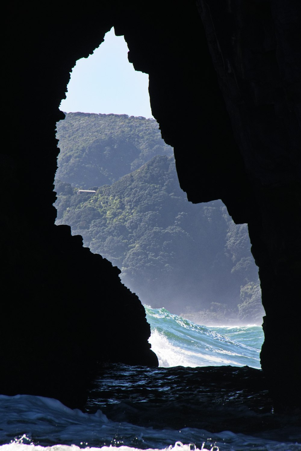 a view of the ocean from inside a cave