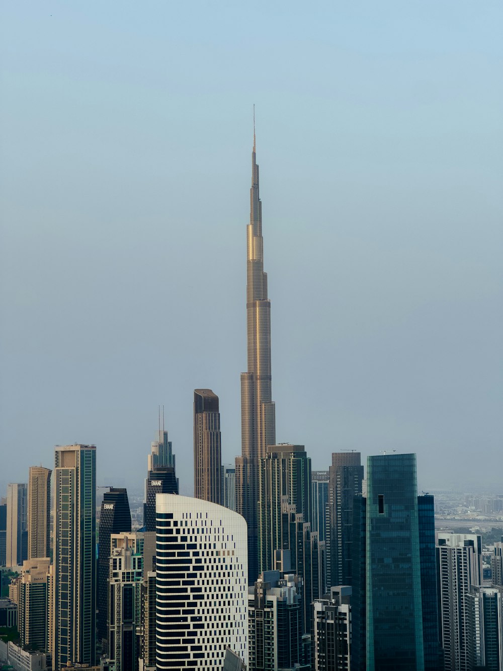 a tall building towering over a city filled with tall buildings