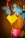 Colorful paper decorations including blue flower shapes and yellow and pink heart shapes are hanging from strings along with orange wooden beads.