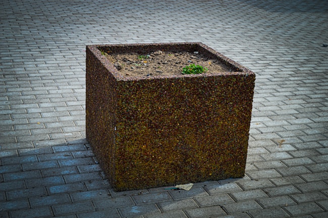 Close-up of a finely crafted concrete planter with textured surface.