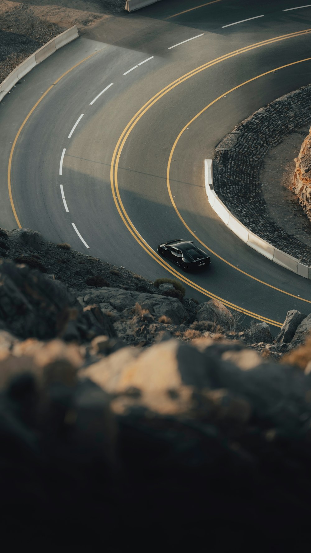 a car is driving down a curved road