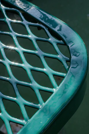 Close-up of a sturdy aluminum-framed table with a smooth fiberglass surface, perfect for outdoor use.
