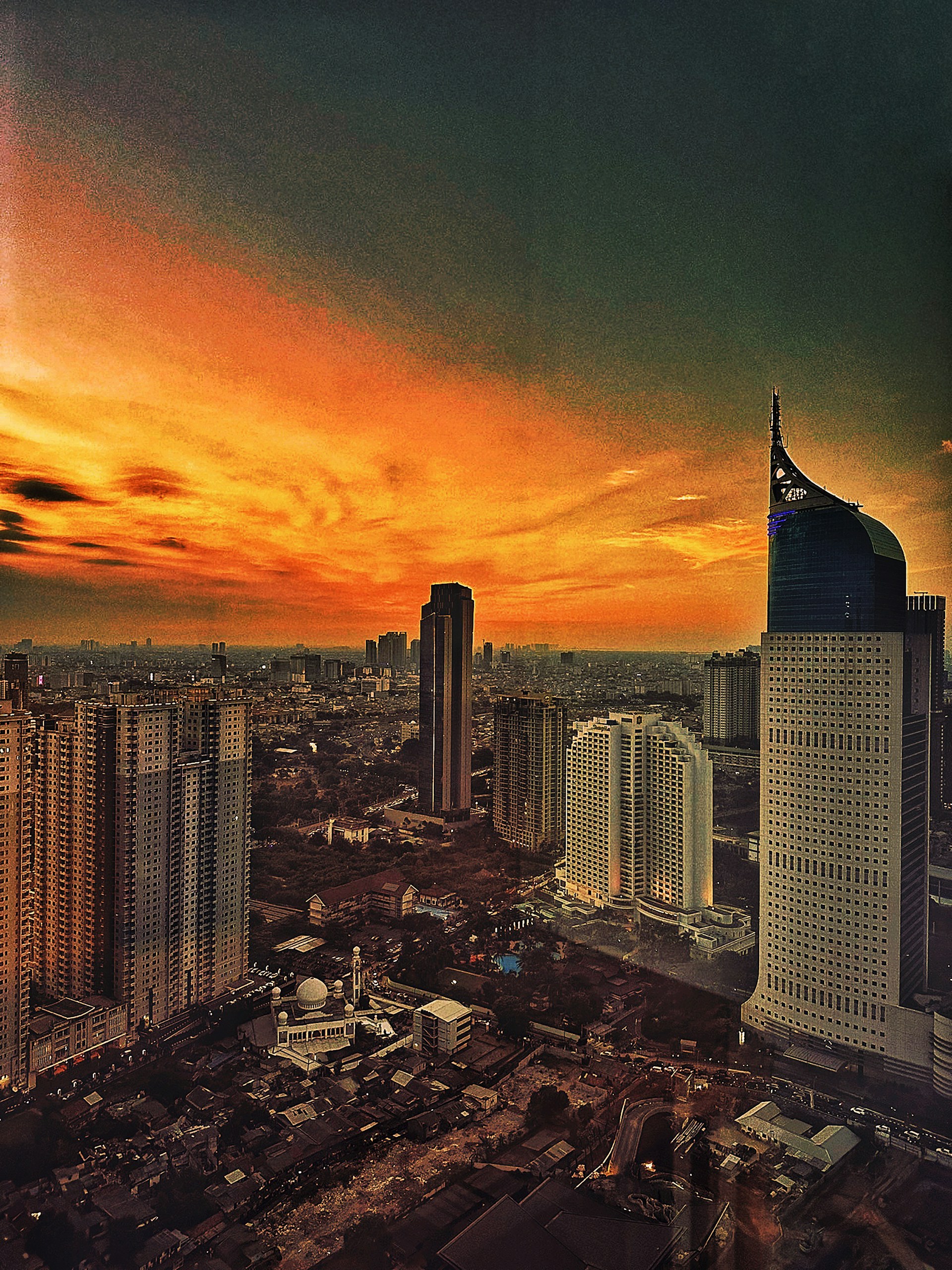 A bustling city skyline at sunset, showcasing a mix of modern skyscrapers and historic buildings, perfect for budget-friendly urban adventures.