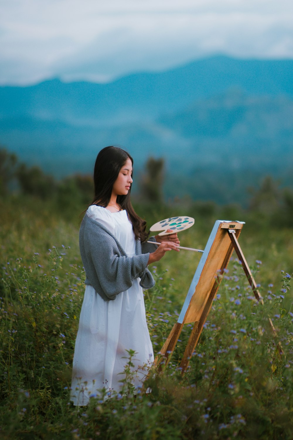 a woman in a white dress holding a frisbee