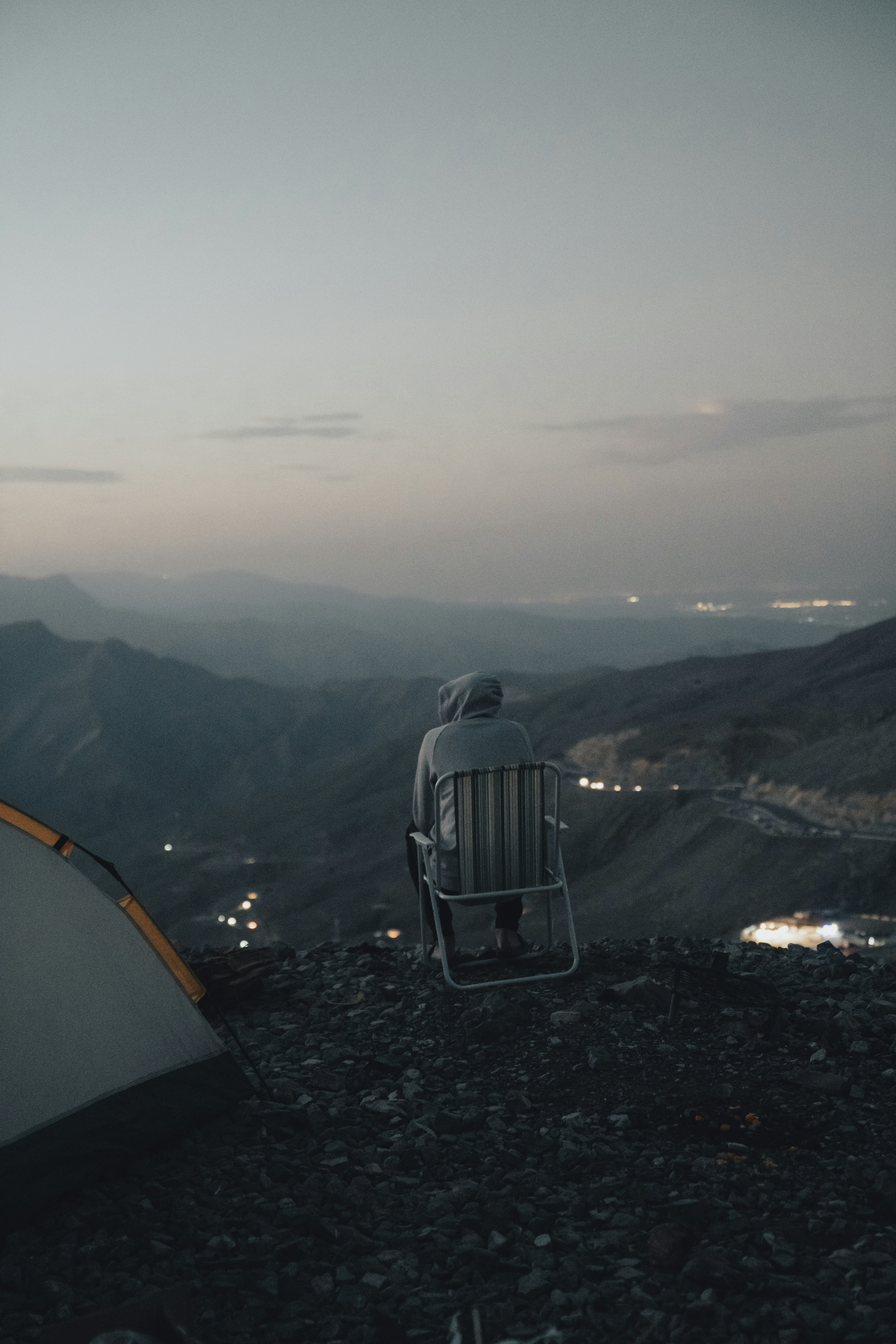 a man sitting in a chair on top of a mountain