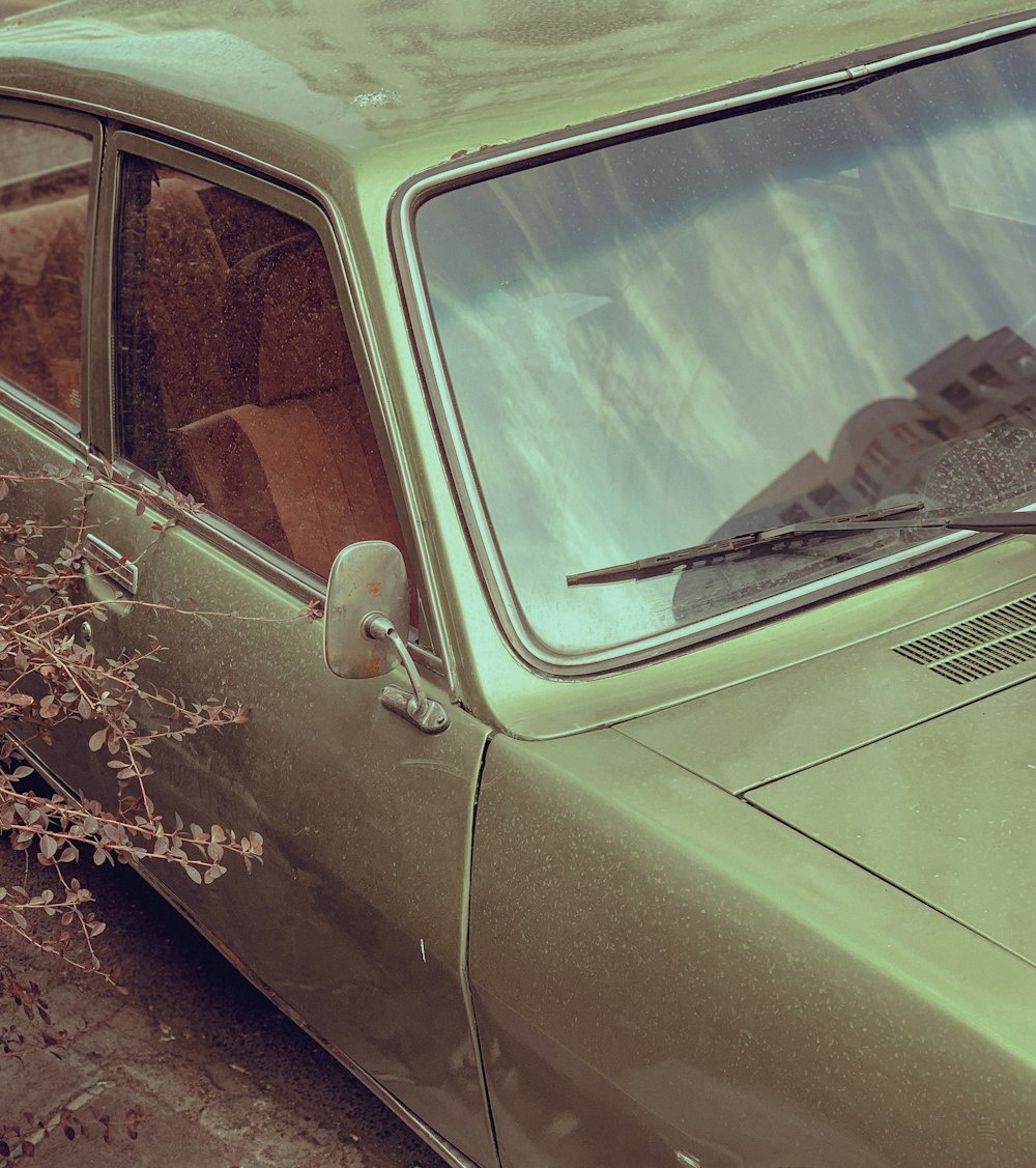 a green car parked on the side of the road