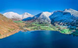 Snow-capped peaks surrounding the serene lakes of Queenstown, New Zealand.