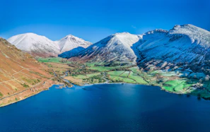 Snow-capped peaks surrounding the serene lakes of Queenstown, New Zealand.