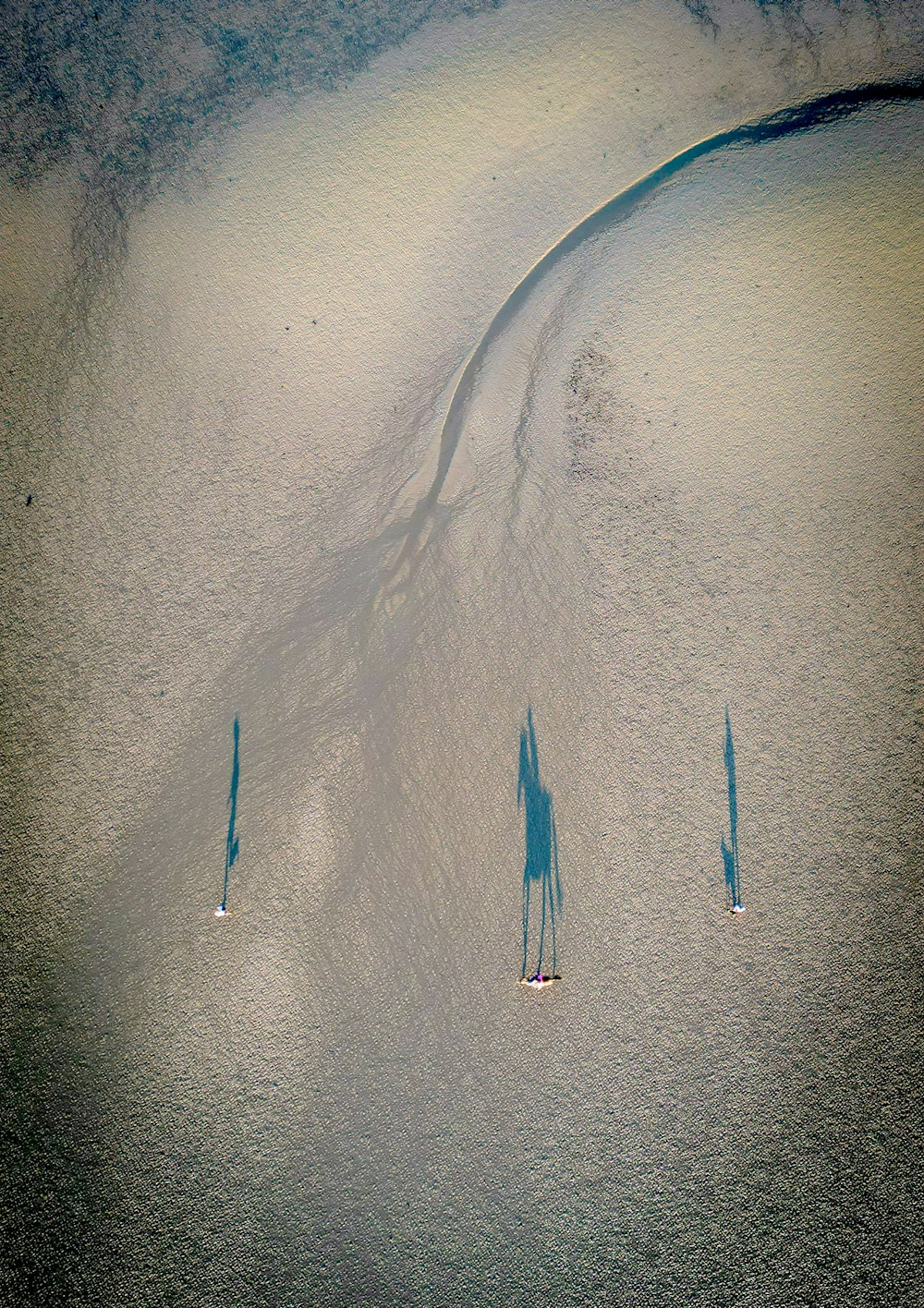 a group of people riding skis on top of a snow covered slope