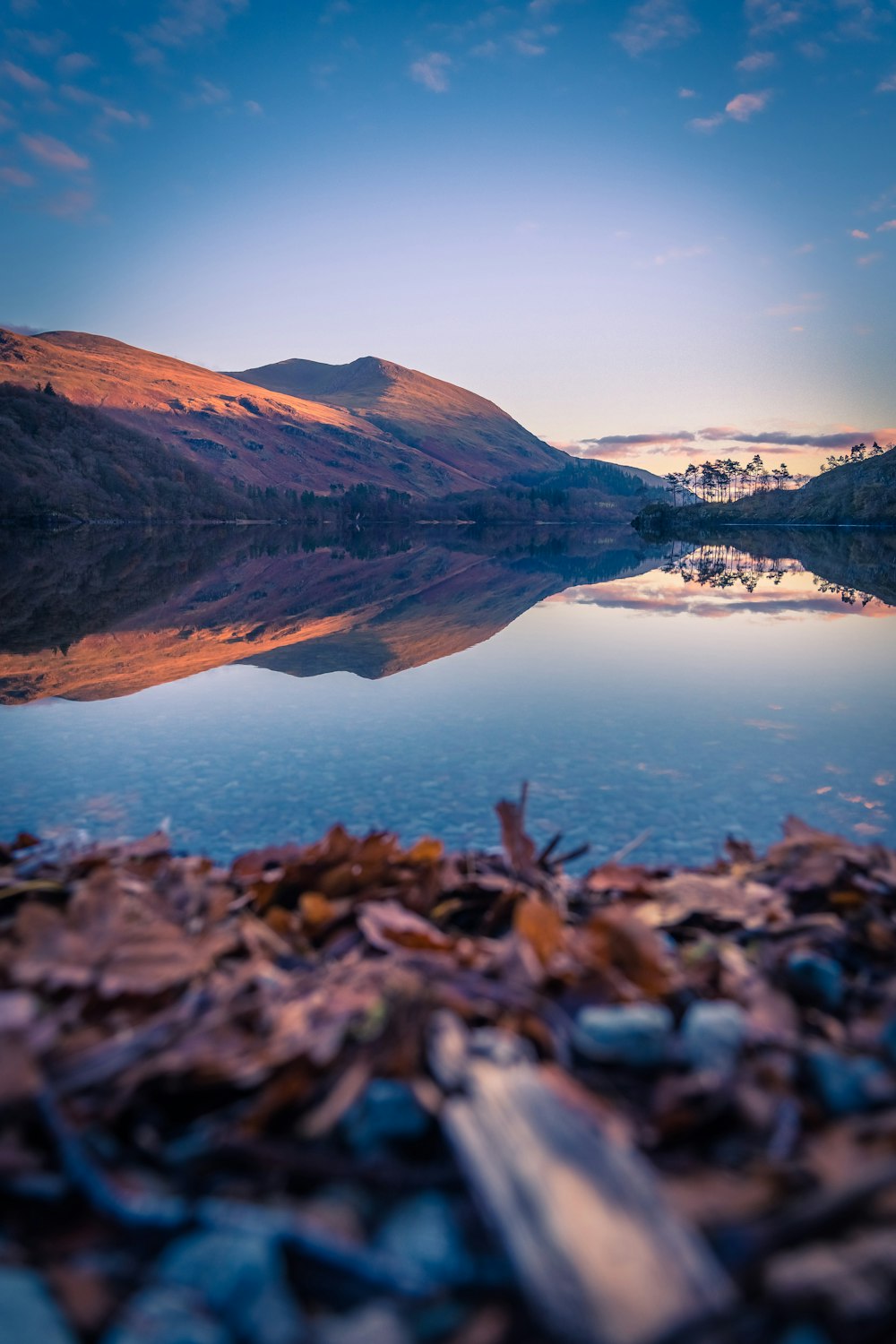 a body of water surrounded by a mountain range