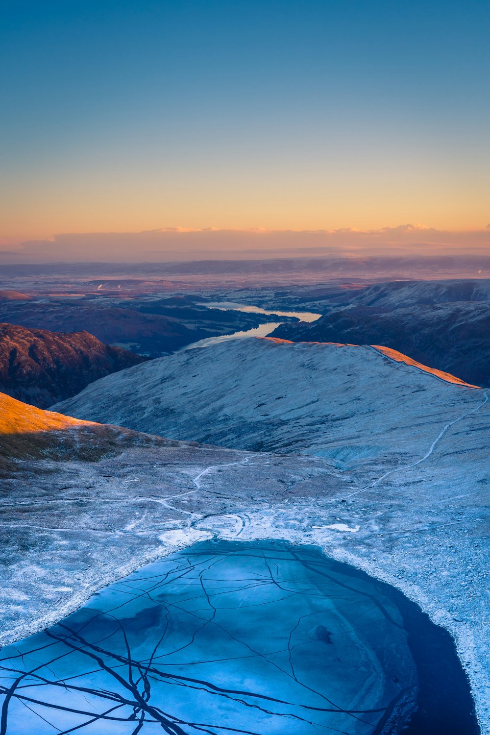 a view of a lake in the middle of a mountain range