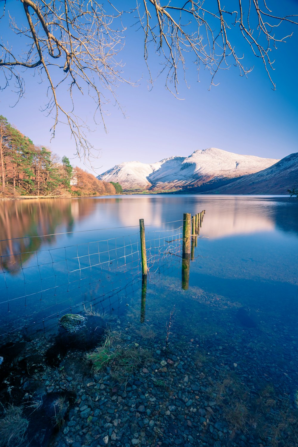 a body of water with mountains in the background