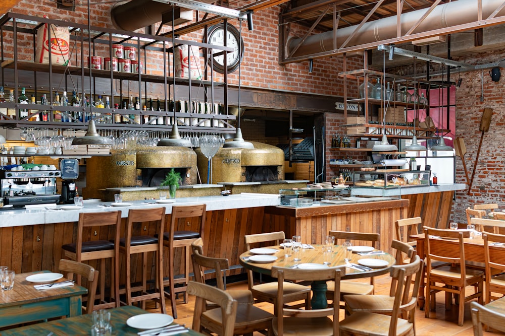 a restaurant filled with lots of wooden tables and chairs