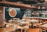 a restaurant with wooden tables and chairs