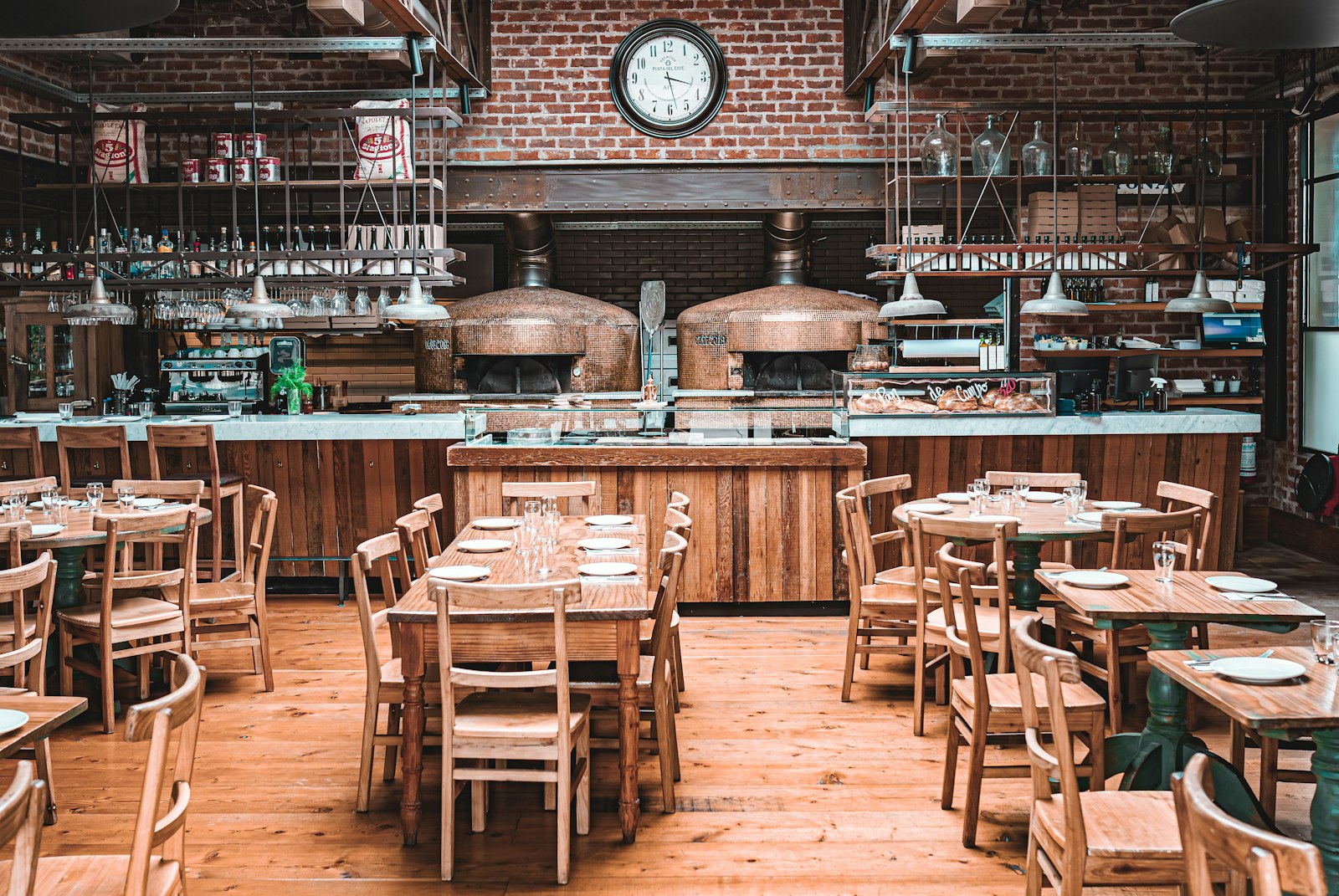 A pizzeria interior with wooden tables and chairs