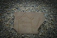 An ancient spiritual symbol engraved on a smooth black stone with faint golden light.