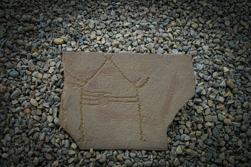 An ancient symbol carved into weathered stone, glowing softly in twilight.