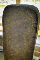 Dark, rune-etched stone tablet glowing with ancient Nordic symbols.