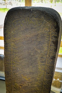 Close-up of ancient Viking runes carved on smooth stones.