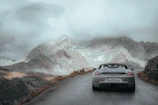 A sleek sports car speeding along a winding mountain road.