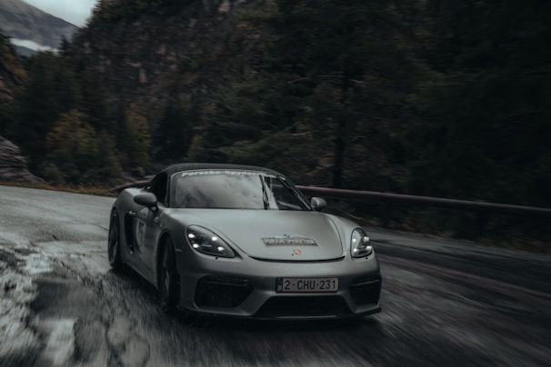 A sleek modern car driving on a winding road.