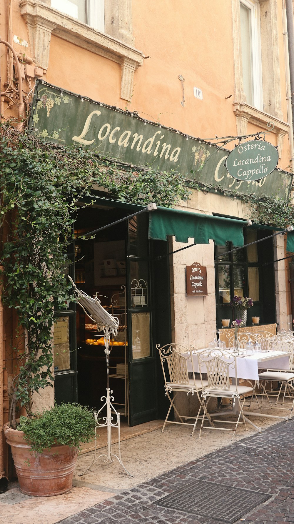 a restaurant with tables and chairs outside of it