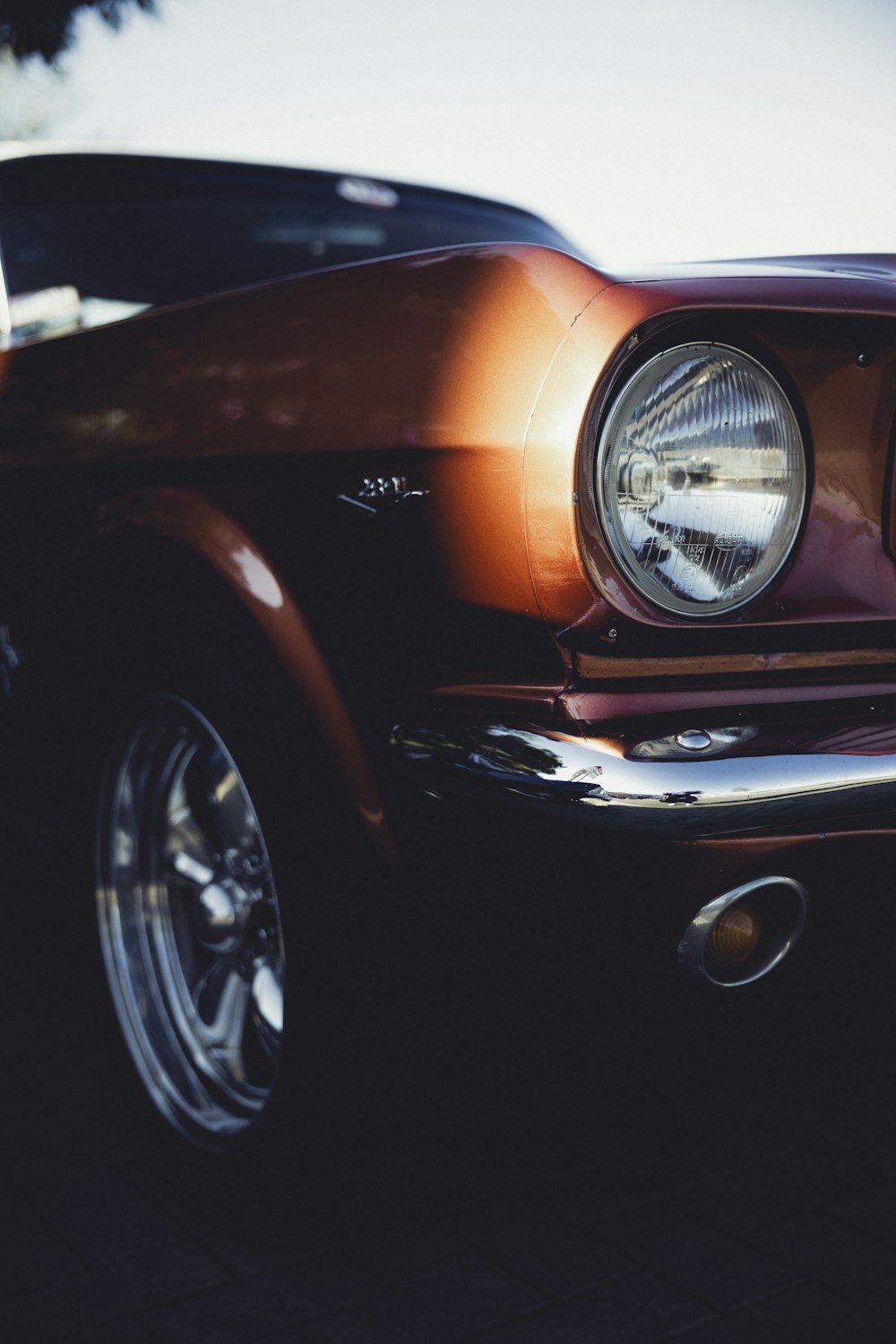 a close up of a car's headlights on a street