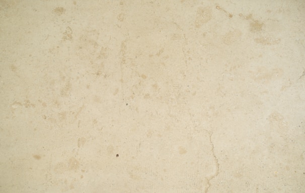 Garage floor featuring a warm beige flake epoxy finish with subtle speckles.
