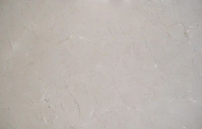Large slabs of grey marble with natural veining displayed in a showroom.