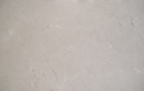 A close-up view of a light gray marble surface with natural veining and subtle variations in texture.