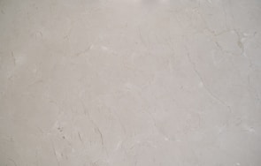 A close-up view of a light gray marble surface with natural veining and subtle variations in texture.