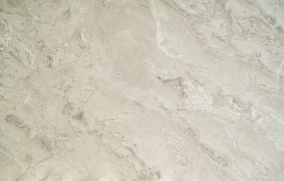 Close-up of a polished marble wall showcasing natural stone cladding with sleek mechanical fittings.