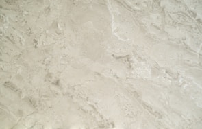 Close-up of a polished marble countertop gleaming under soft light.