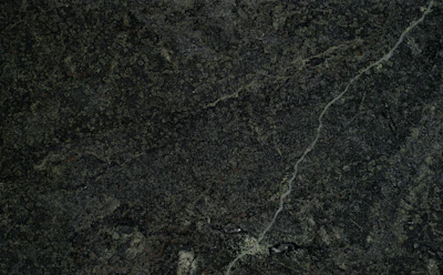 Textured mineral surface reflecting resilience and strength under pressure.